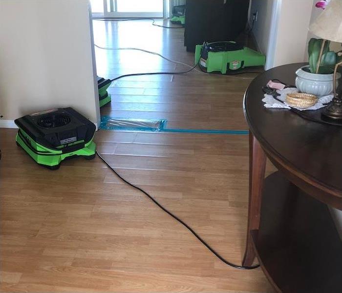 wood floor in a home with water damage and SERVPRO equipment set-up