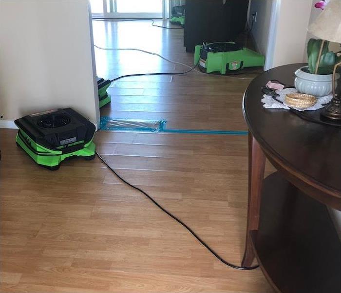 wood floor in a home with water damage and SERVPRO equipment set-up